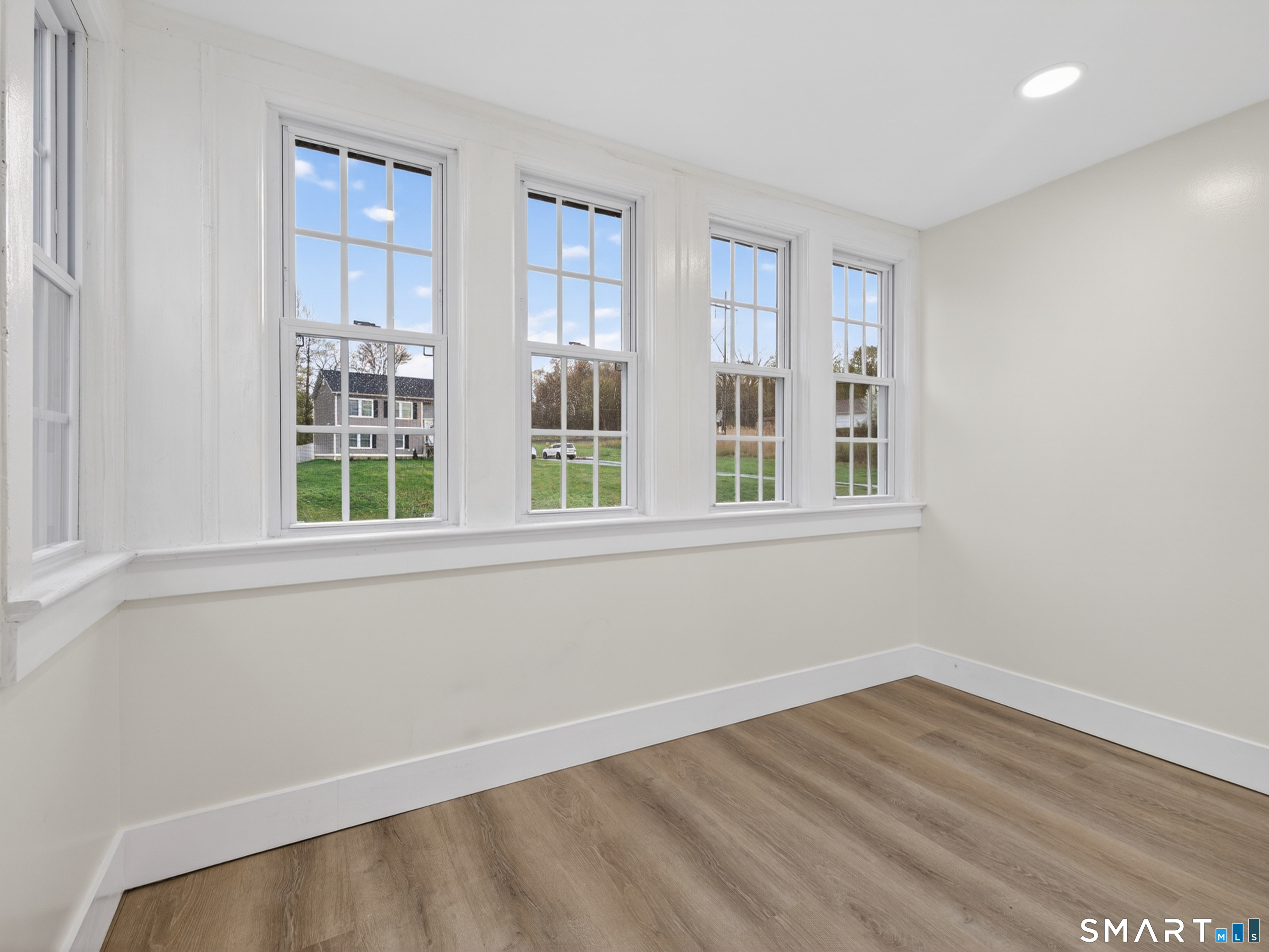 380 Main Street Meriden, CT 06451 - Photo 23 of 40 a view of empty room with wooden floor and fan