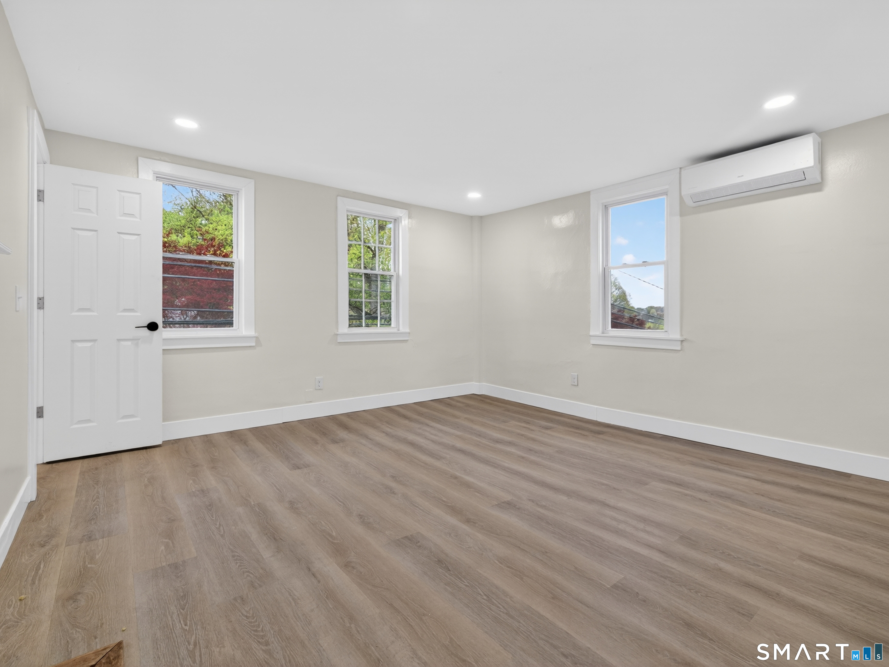 380 Main Street Meriden, CT 06451 - Photo 24 of 40 an empty room with wooden floor and windows
