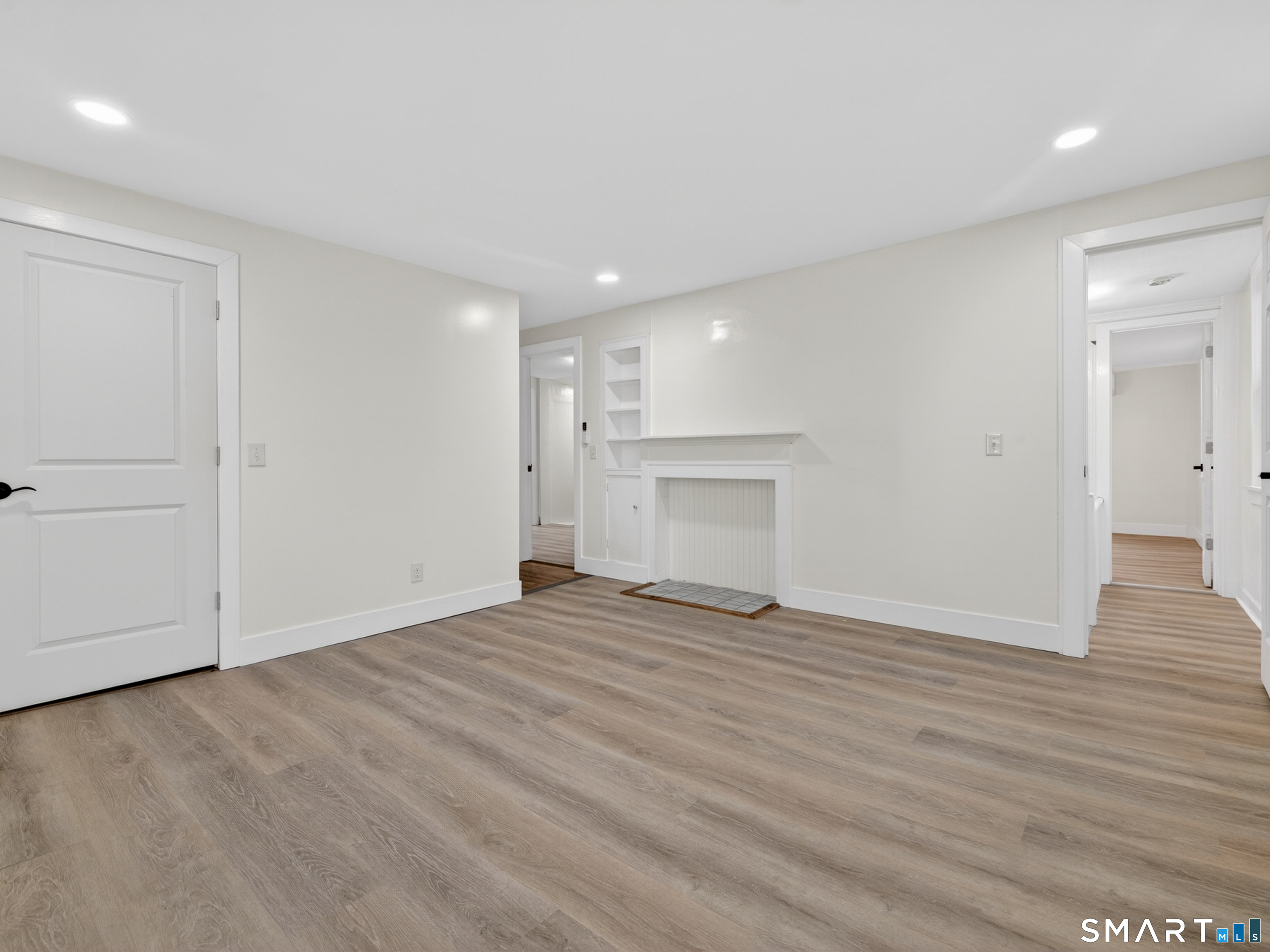 380 Main Street Meriden, CT 06451 - Photo 26 of 40 a view of empty room with wooden floor and fireplace