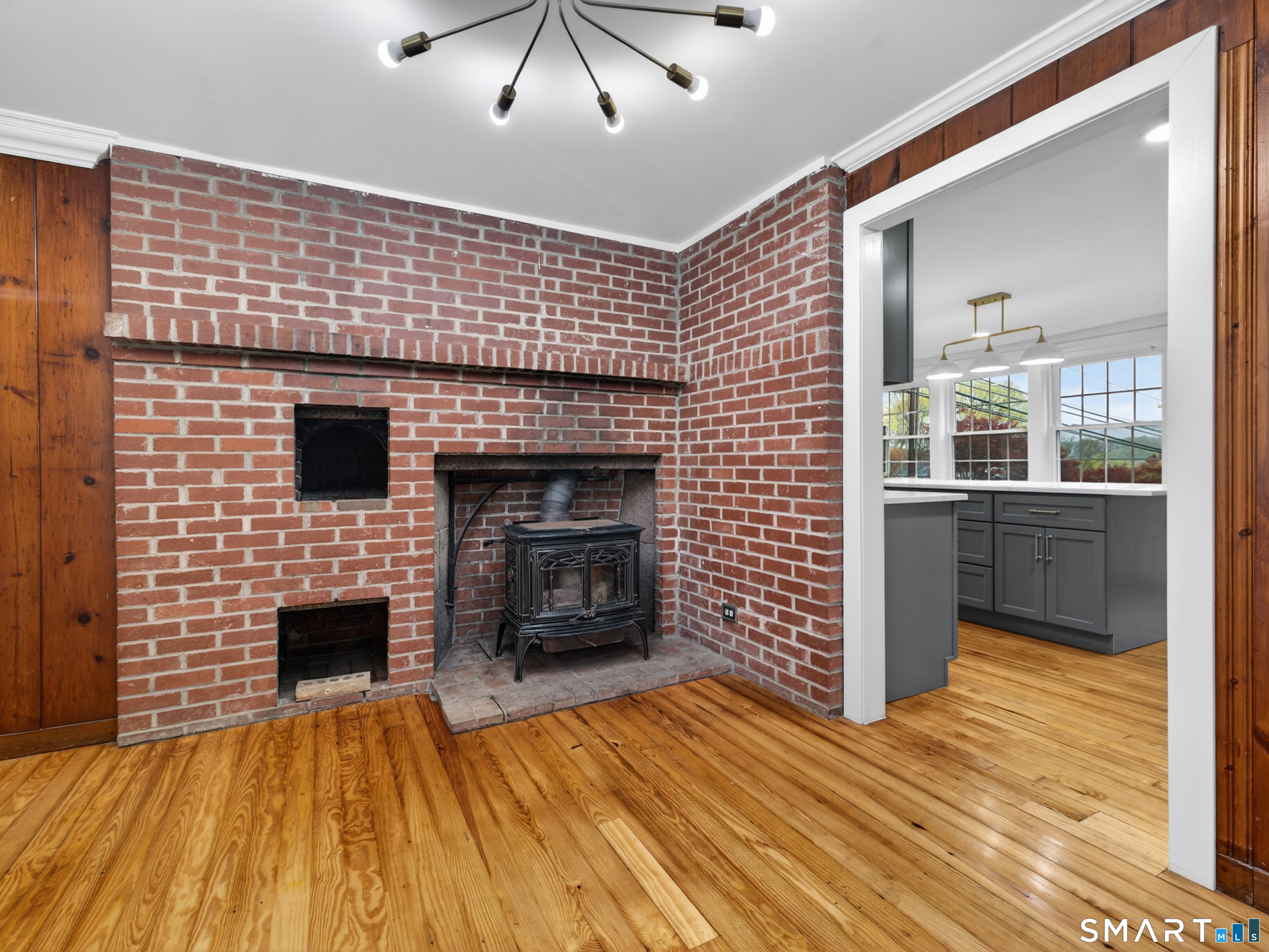 380 Main Street Meriden, CT 06451 - Photo 6 of 40 a view of empty room with wooden floor and fireplace