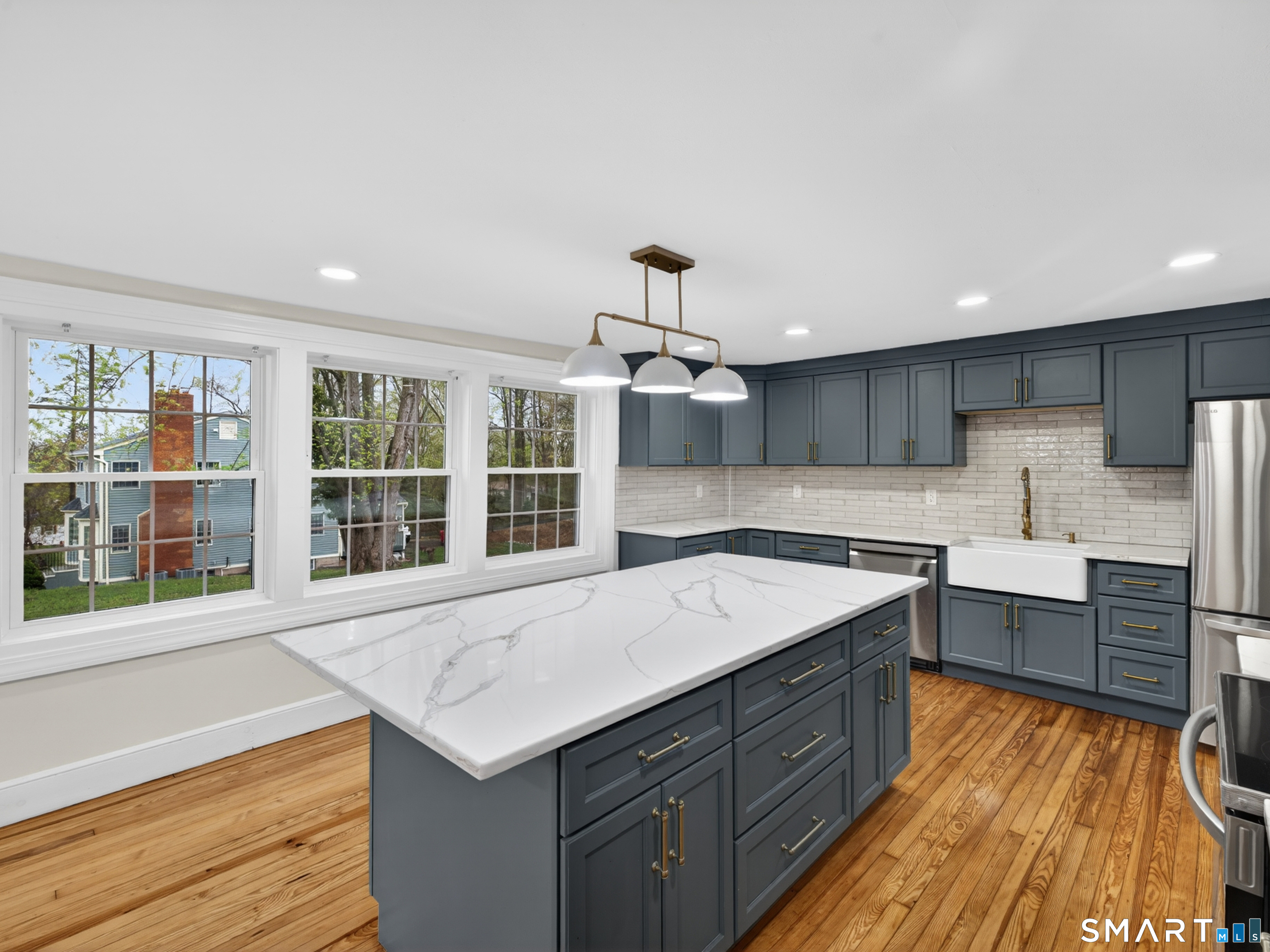 380 Main Street Meriden, CT 06451 - Photo 7 of 40 a kitchen with a stove a sink and a refrigerator