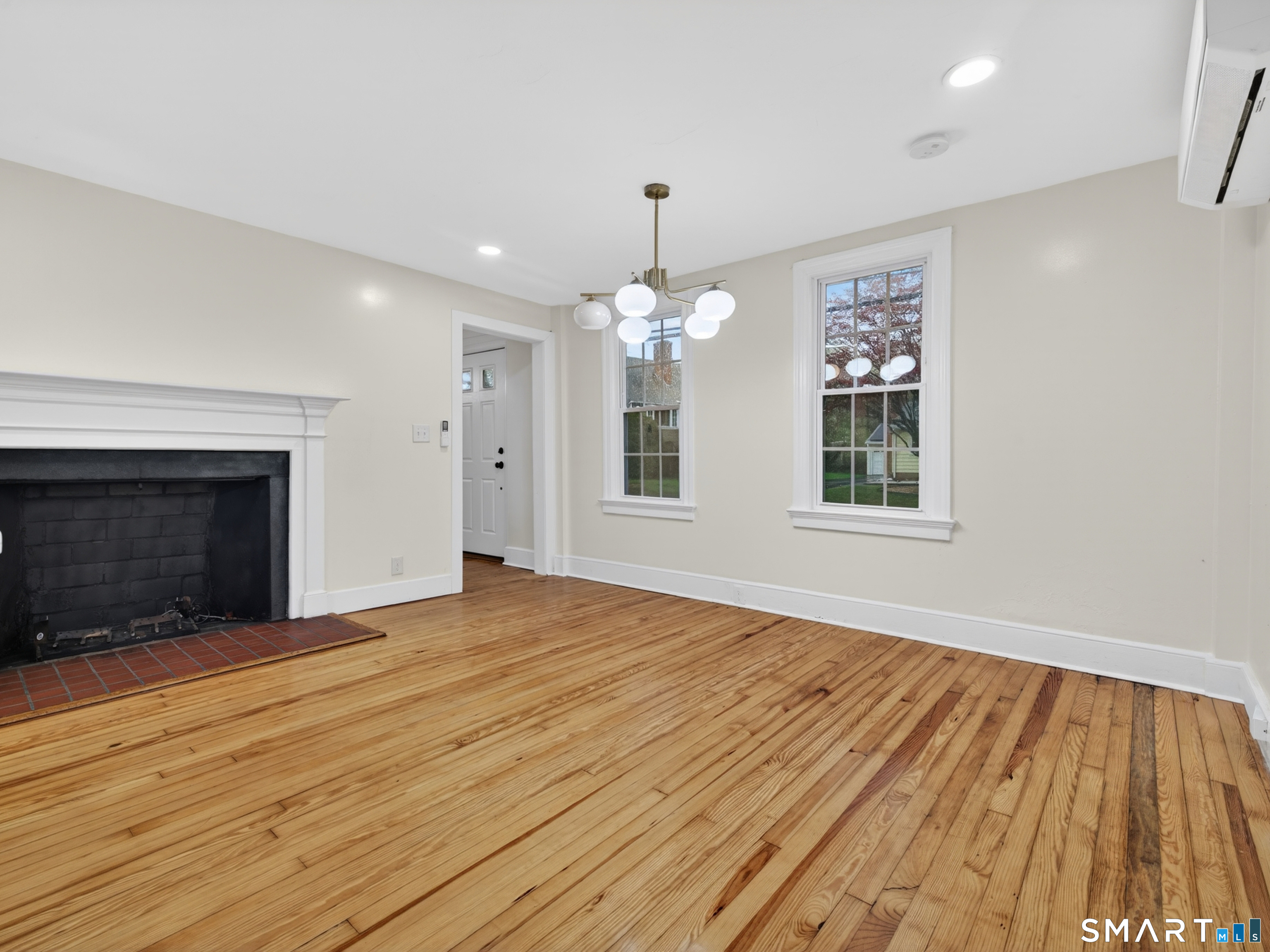 380 Main Street Meriden, CT 06451 - Photo 10 of 40 a view of an empty room with wooden floor fireplace and a window