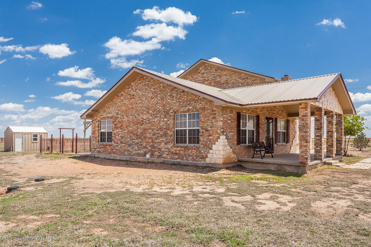 10201 Bushland Road Amarillo, TX 79119 - Photo 22 of 62 a front view of house with yard outdoor seating and barbeque oven