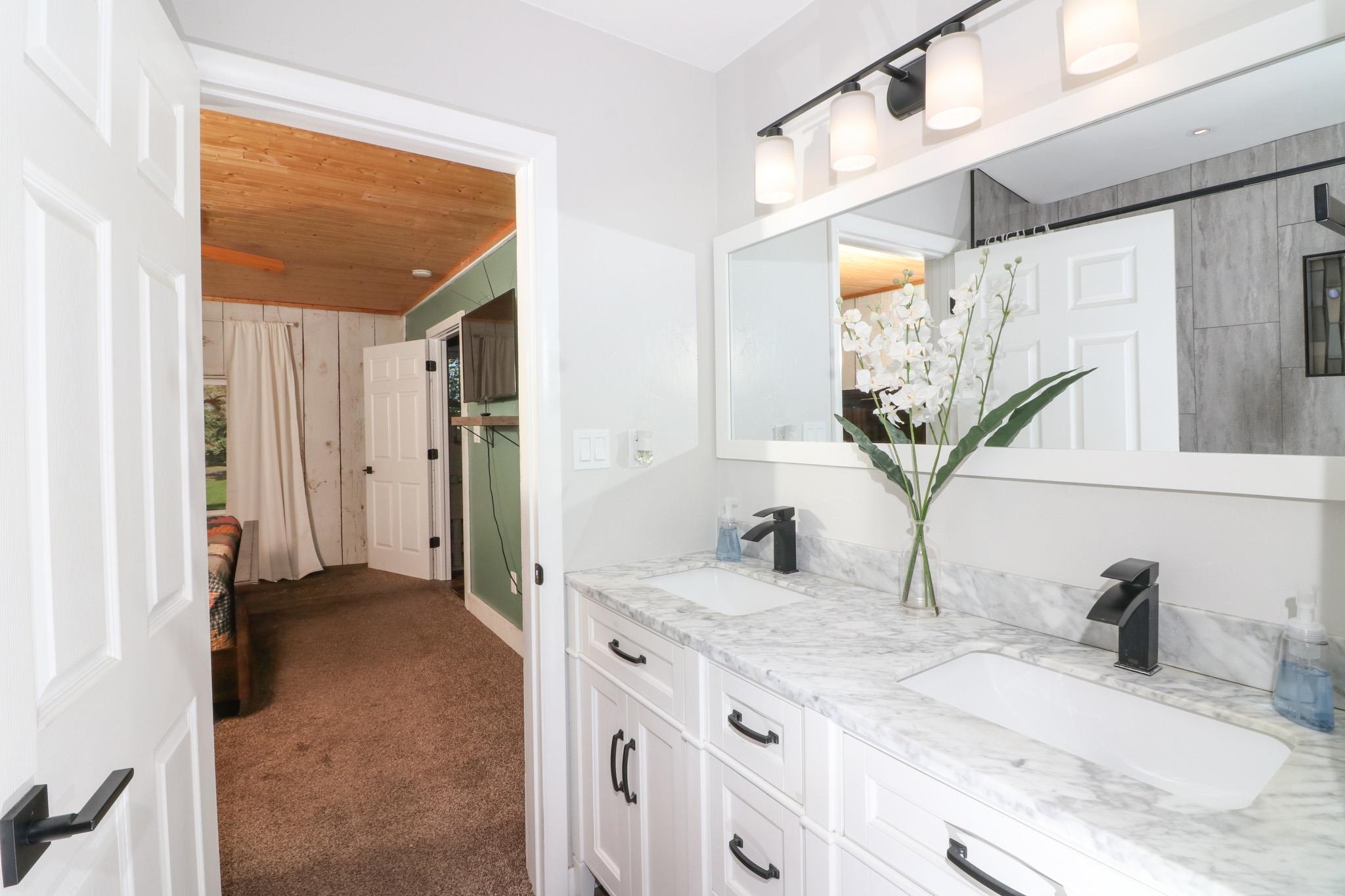 607-28 28 3/4 Road Grand Junction, CO 81506 - Photo 14 of 42 a bathroom with a granite countertop sink and a mirror