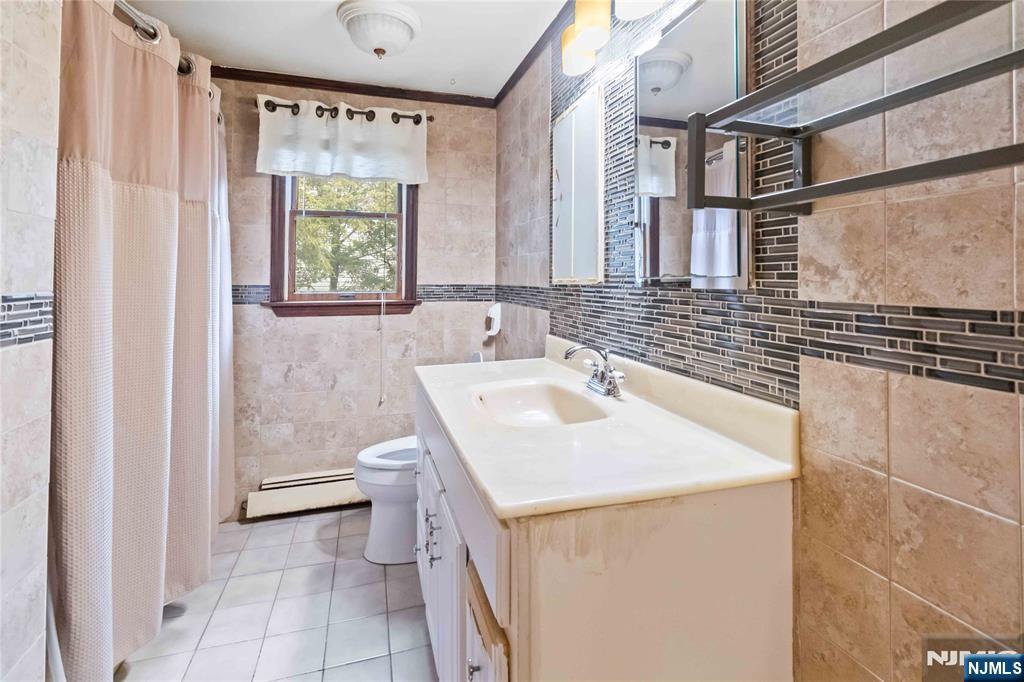 366 Spring Valley Road Paramus, NJ 07652 - Photo 16 of 23 a bathroom with a sink a toilet and vanity