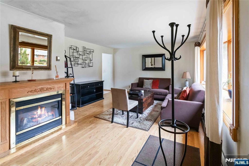 366 Spring Valley Road Paramus, NJ 07652 - Photo 4 of 23 a living room with furniture a window and a fireplace