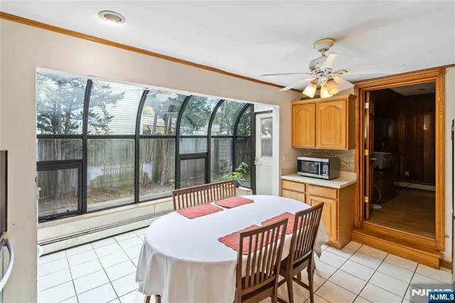 a dining room with furniture a chandelier and window