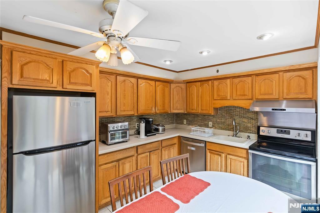 366 Spring Valley Road Paramus, NJ 07652 - Photo 7 of 23 a kitchen with stainless steel appliances a refrigerator sink and cabinets