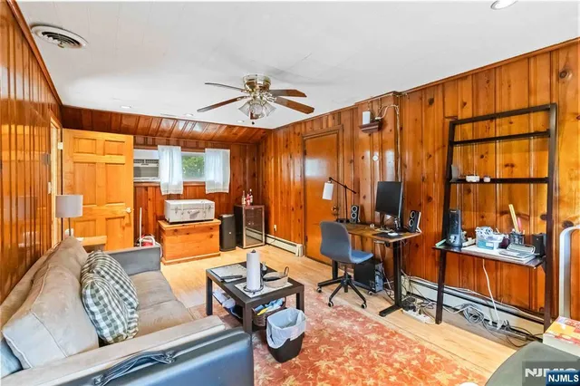 a living room with patio furniture and a large window