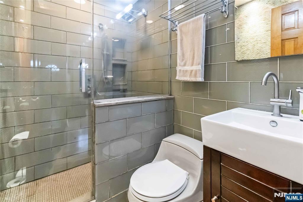366 Spring Valley Road Paramus, NJ 07652 - Photo 10 of 23 a bathroom with a sink a toilet and shower