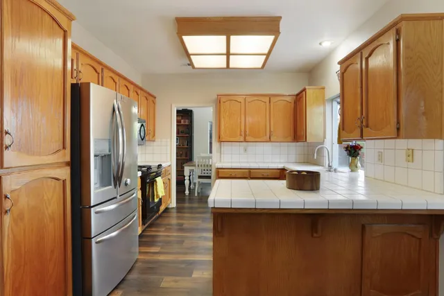 a kitchen with stainless steel appliances granite countertop a sink and cabinets