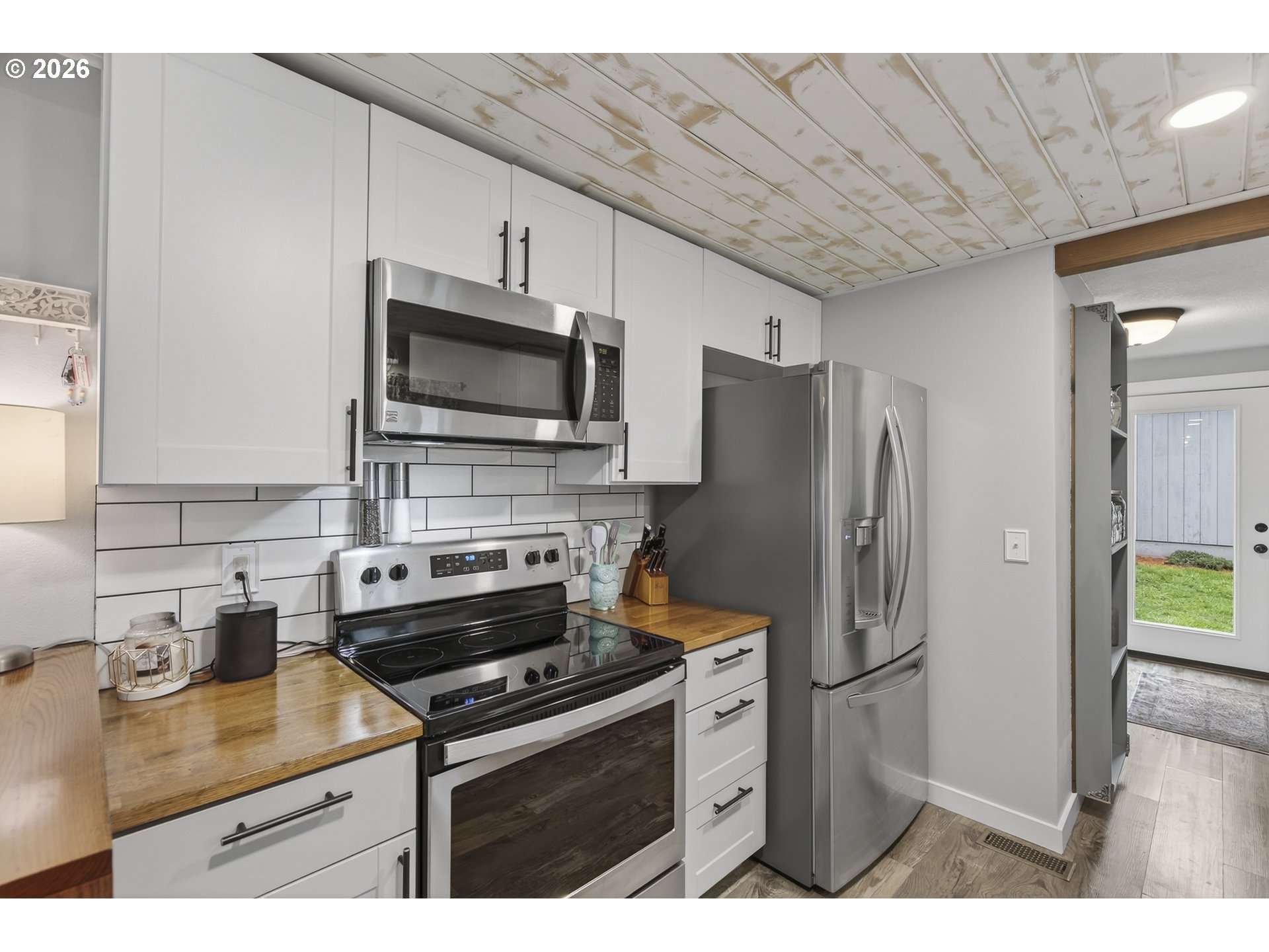615 Northeast 257th Avenue Camas, WA 98607 - Photo 15 of 48 a kitchen with stainless steel appliances a stove a refrigerator a sink a stove top oven with wooden floor