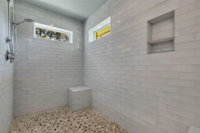 a bathroom with a toilet and a shower