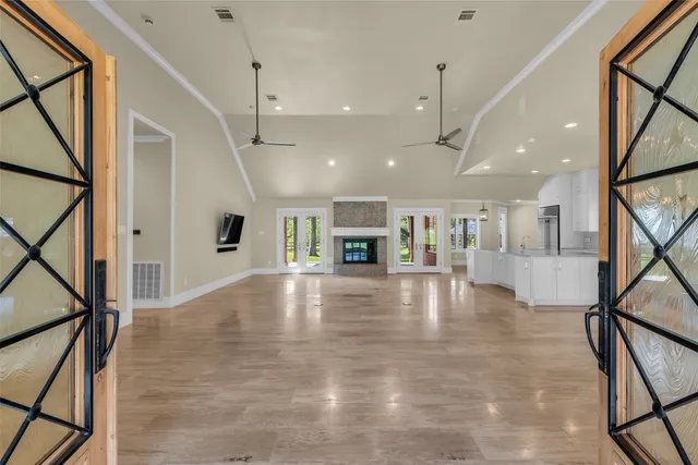 a view of an empty room with furniture a fireplace