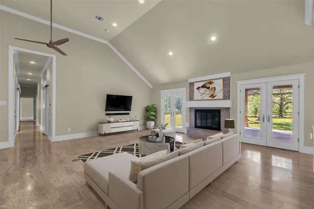 a spacious bedroom with a bed and a chandelier