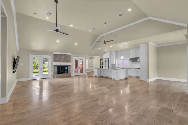 a view of kitchen and a livingroom with furniture wooden floor kitchen view and a window