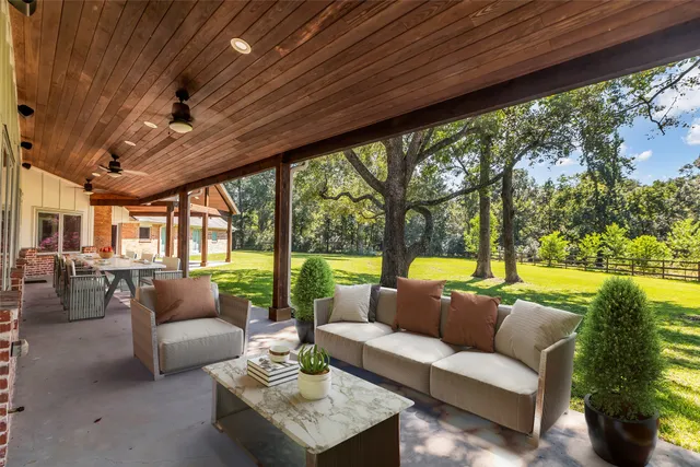 a dining room with wooden floor a chandelier a wooden table and chairs