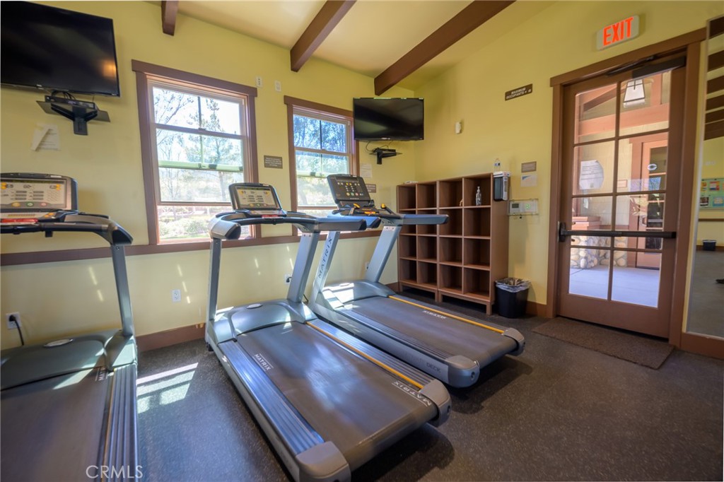 11735 Bunting Circle Corona, CA 92883 - Photo 32 of 38 a living room with furniture flat screen tv and windows