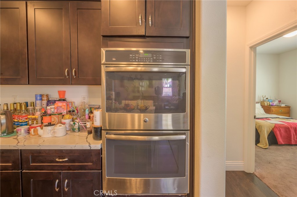 11735 Bunting Circle Corona, CA 92883 - Photo 8 of 38 a kitchen with a refrigerator and a stove