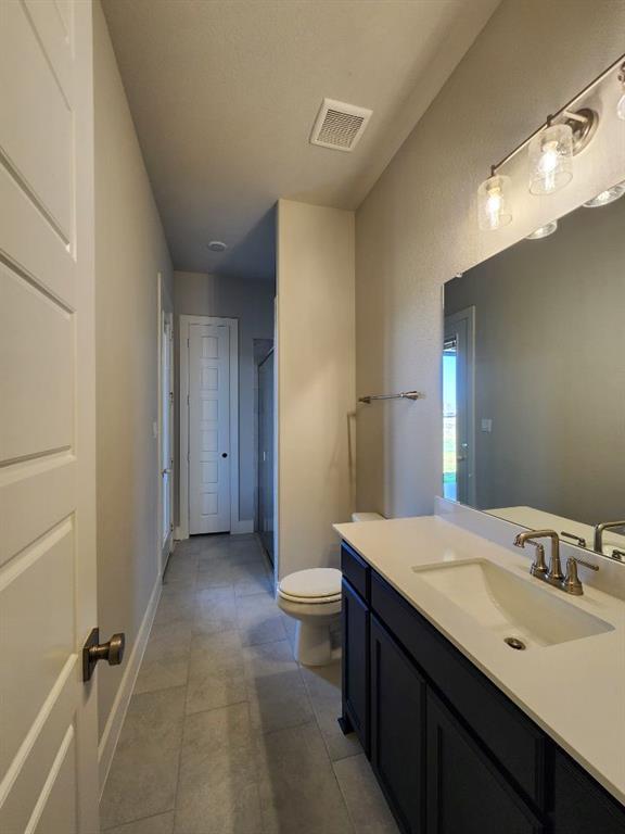 2321 Quartz Street Krum, TX 76249 - Photo 14 of 19 a bathroom with a sink and a mirror