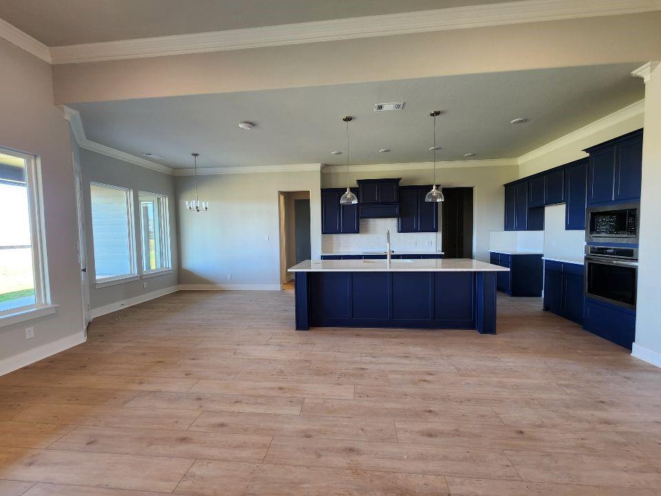 2321 Quartz Street Krum, TX 76249 - Photo 7 of 19 a view of kitchen with kitchen island microwave and cabinets