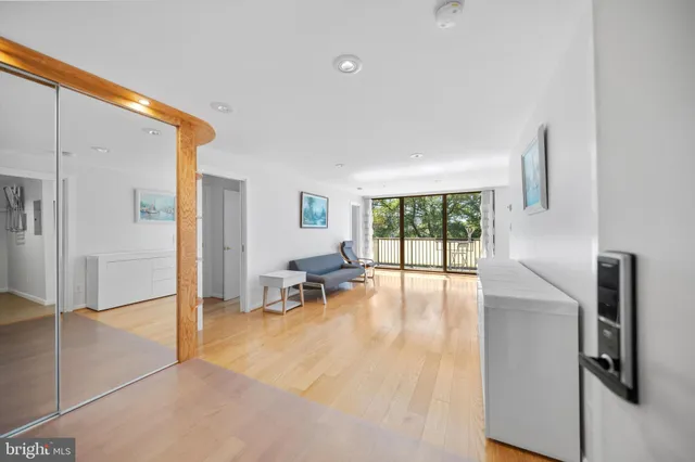 a view of a livingroom with wooden floor and furniture