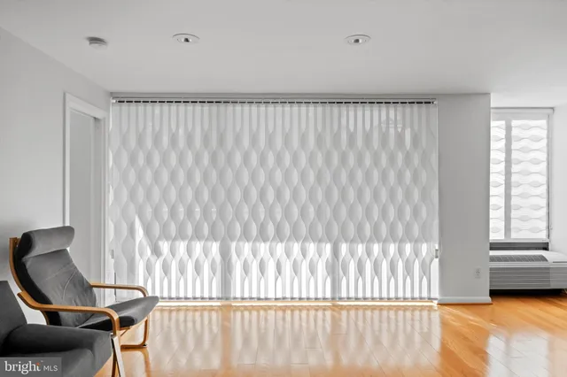 a view of a bedroom with furniture and a window