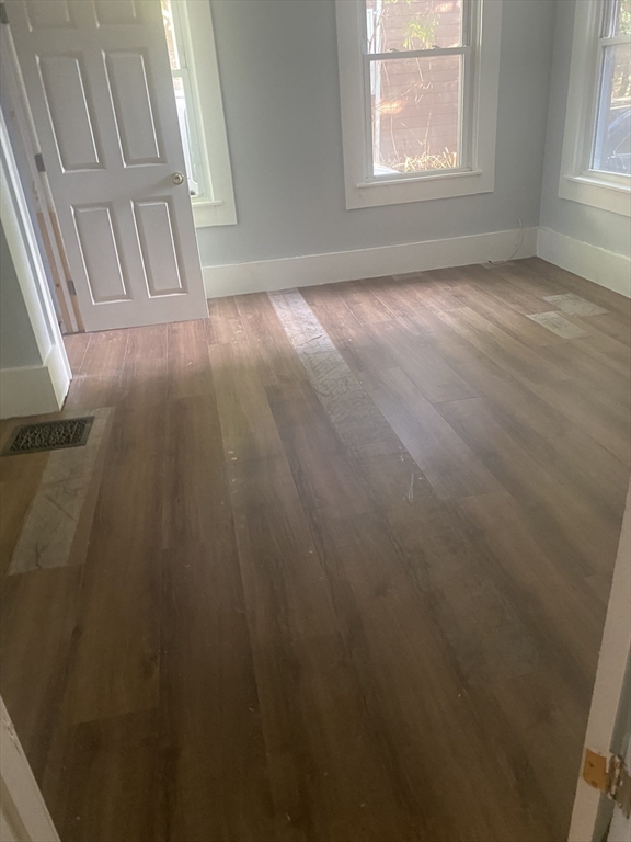 24 Gordon Avenue, Unit 24 Boston, MA 02136 - Photo 11 of 13 an empty room with wooden floor and windows