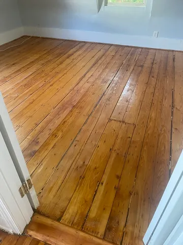 a view of a room with wooden floor