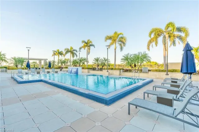 a view of swimming pool with outdoor seating and plants