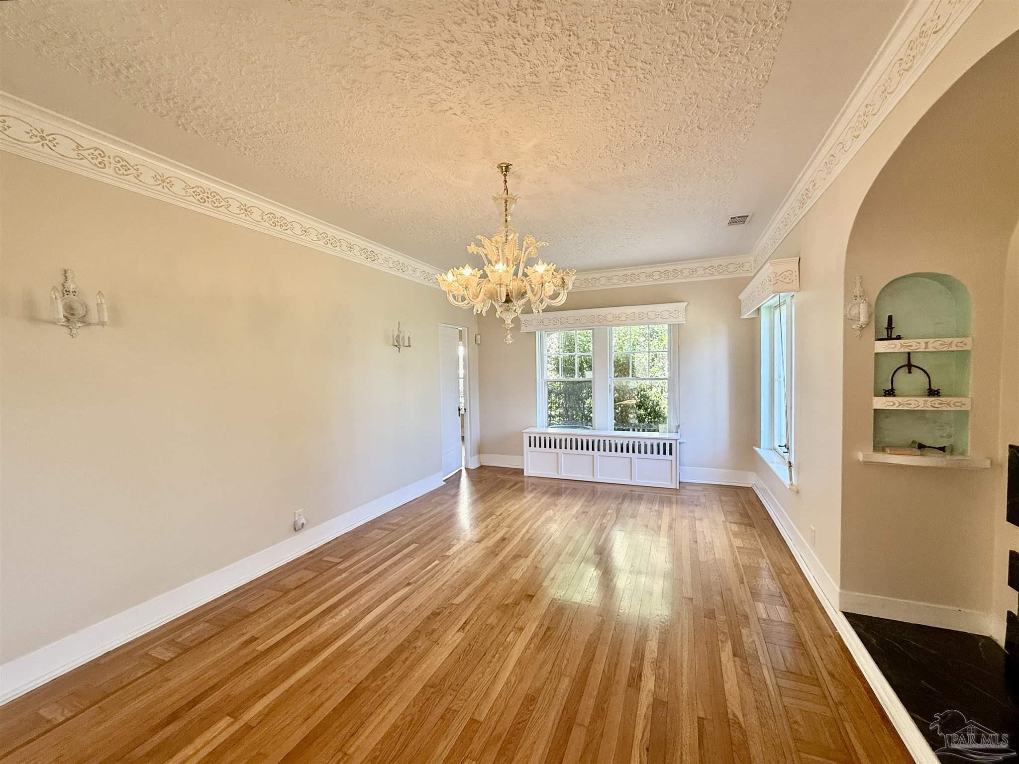 1717 Yates Avenue Pensacola, FL 32503 - Photo 13 of 47 a view of an empty room with window and wooden floor