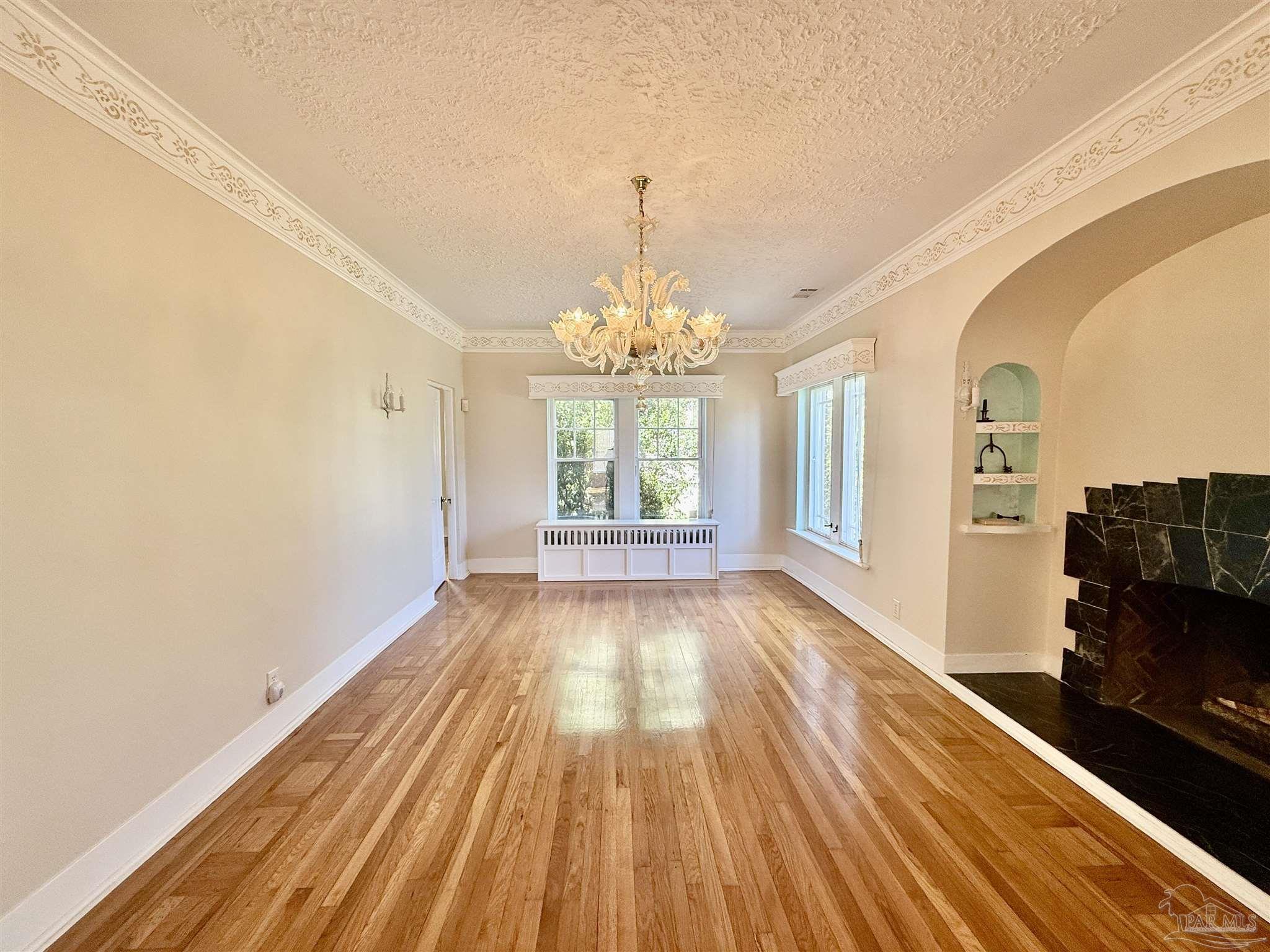 1717 Yates Avenue Pensacola, FL 32503 - Photo 14 of 47 a view of an empty room with a window and wooden floor