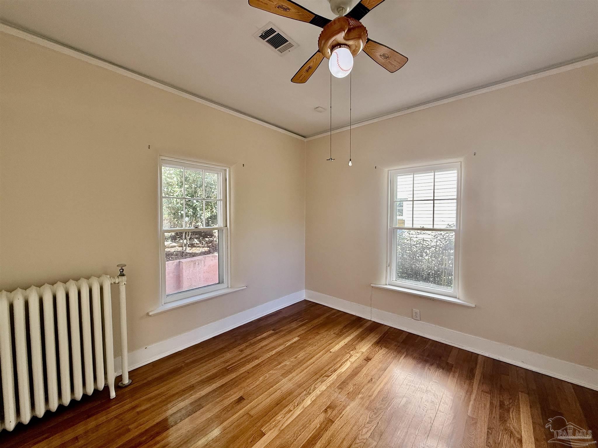 1717 Yates Avenue Pensacola, FL 32503 - Photo 21 of 47 a view of an empty room with wooden floor and a window