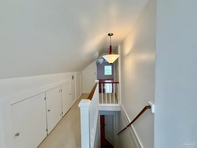a view of staircase with white walls and railing