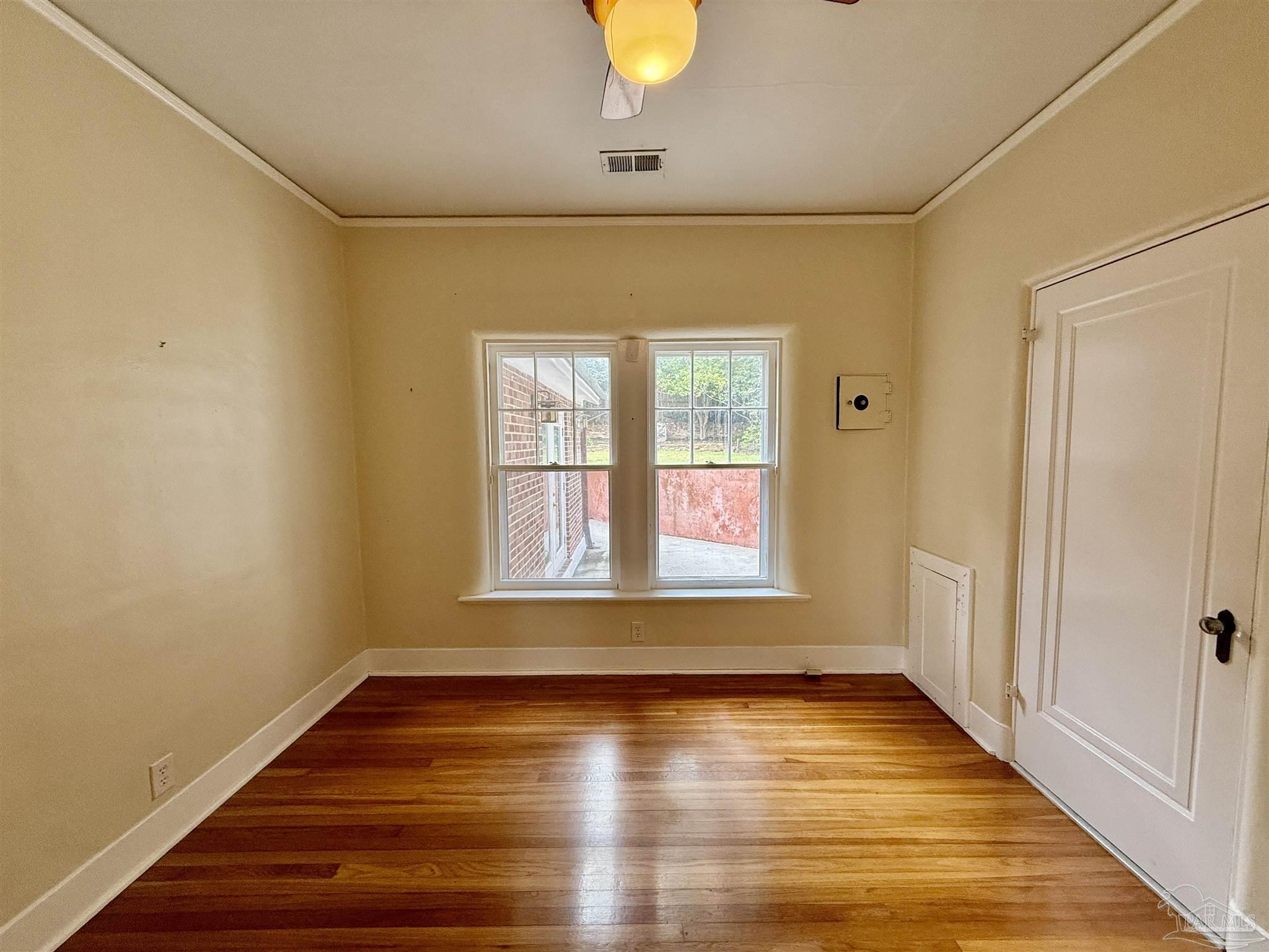 1717 Yates Avenue Pensacola, FL 32503 - Photo 23 of 47 a view of an empty room with wooden floor and a window