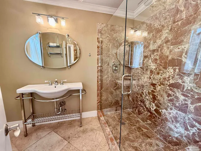 a dining room with wooden floor a chandelier a wooden table and chairs