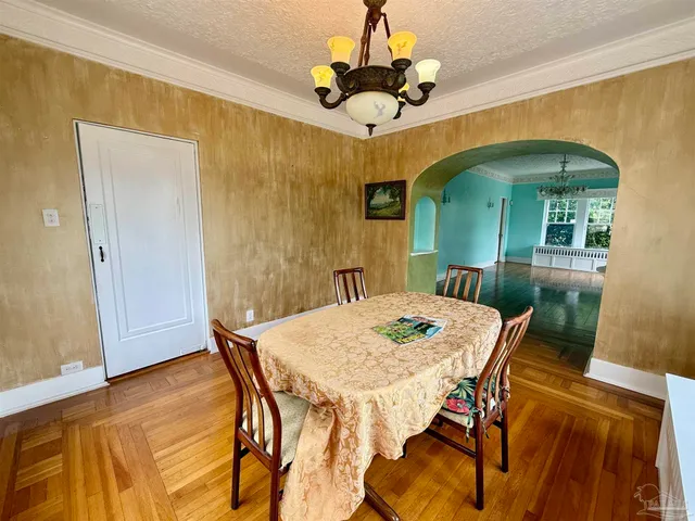a large white kitchen with granite countertop a stove and a sink