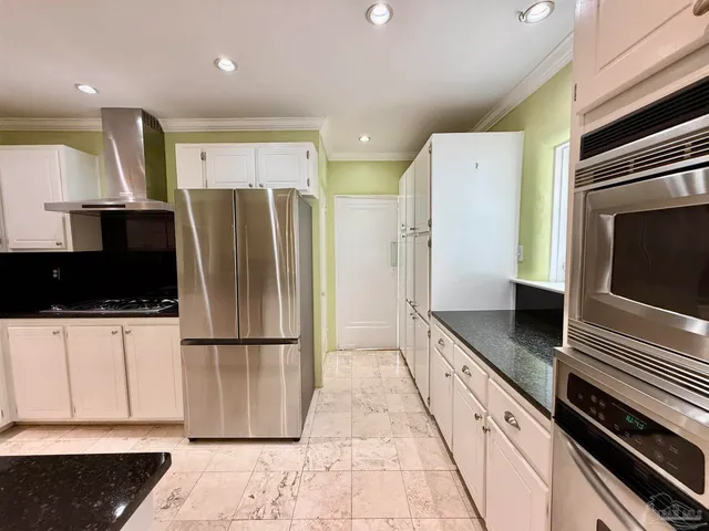 a kitchen with a refrigerator and a sink
