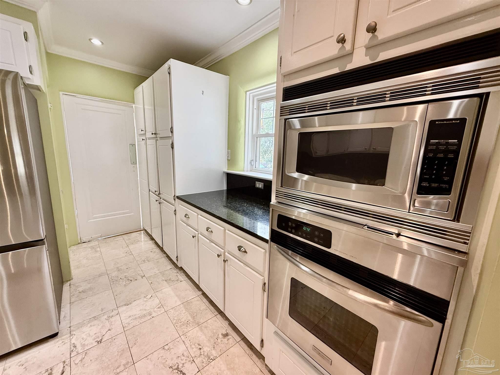 1717 Yates Avenue Pensacola, FL 32503 - Photo 37 of 47 a kitchen with granite countertop cabinets and steel stainless steel appliances