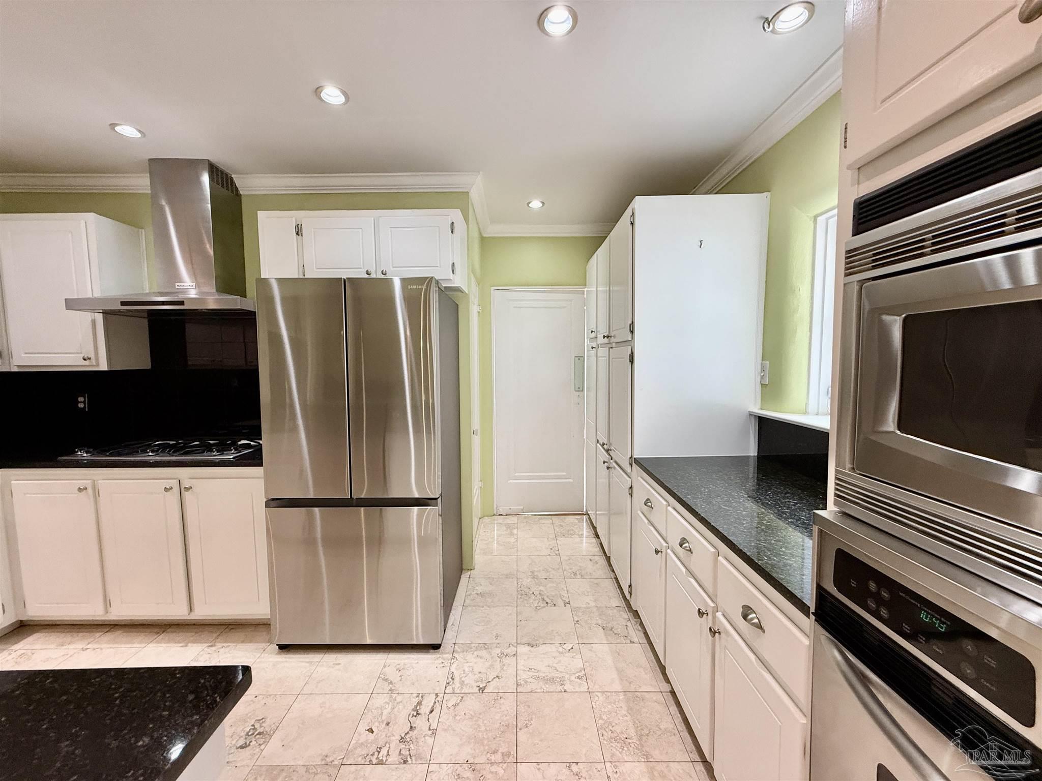 1717 Yates Avenue Pensacola, FL 32503 - Photo 38 of 47 a kitchen with stainless steel appliances kitchen island granite countertop a refrigerator and a stove top oven