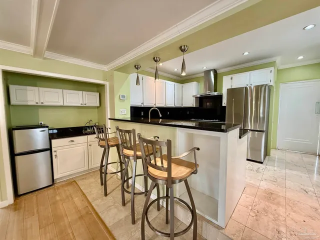 a kitchen with stainless steel appliances kitchen island granite countertop a sink and cabinets