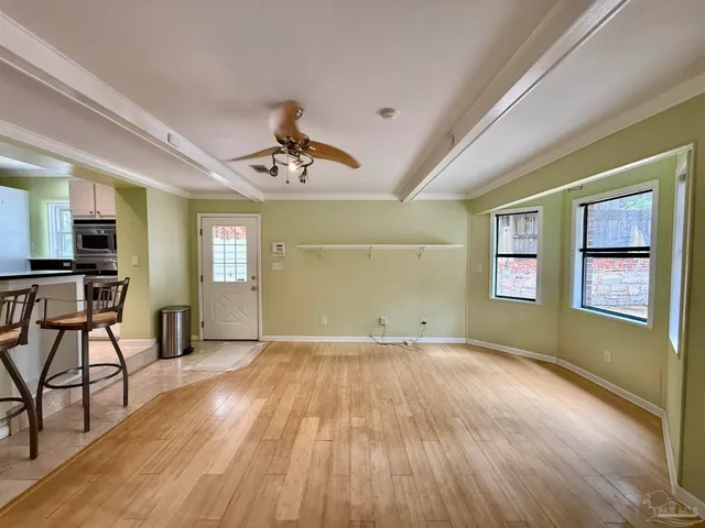 a view of a livingroom with furniture and a ceiling fan