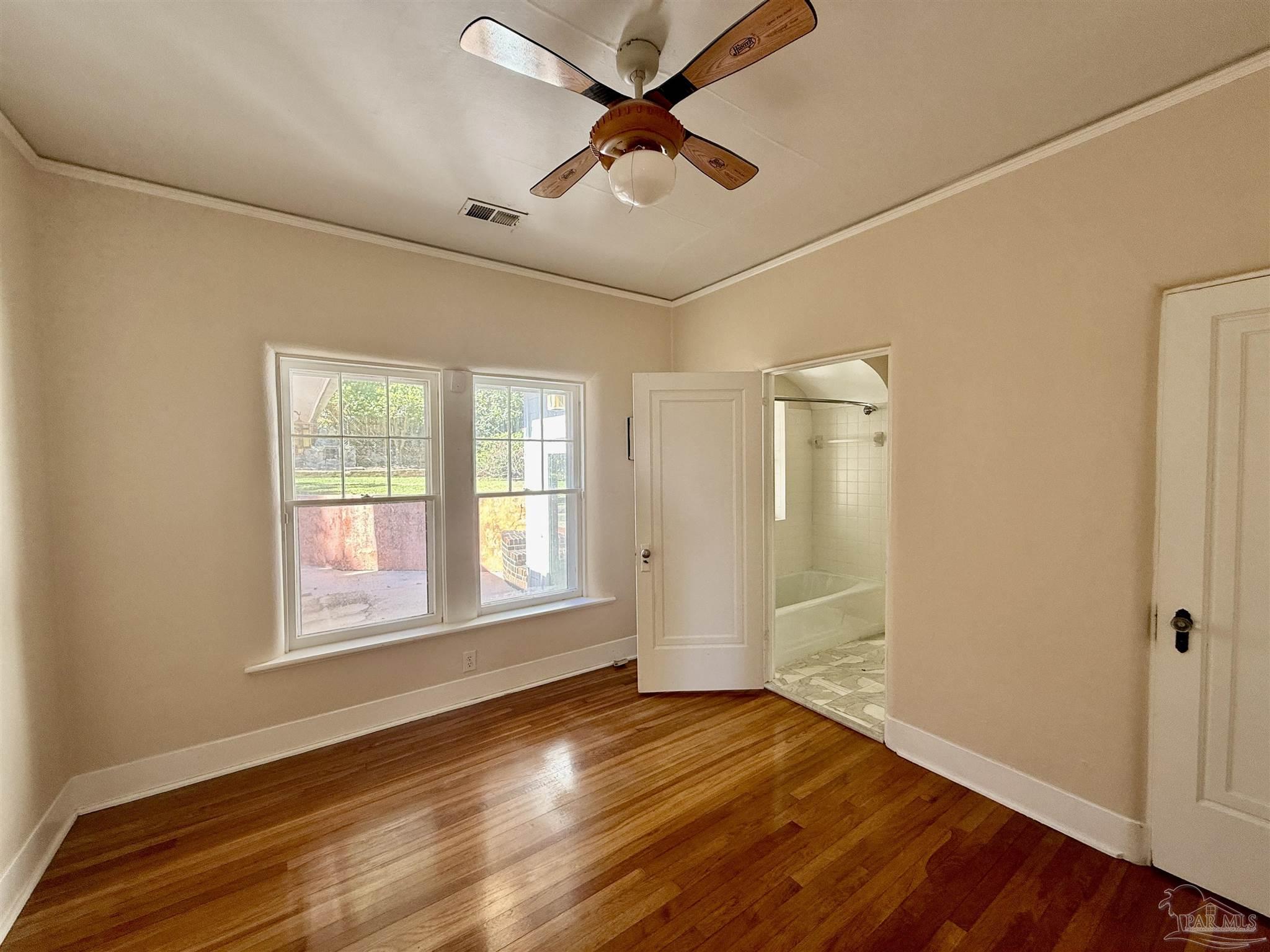 1717 Yates Avenue Pensacola, FL 32503 - Photo 8 of 47 a view of an empty room with window and wooden floor