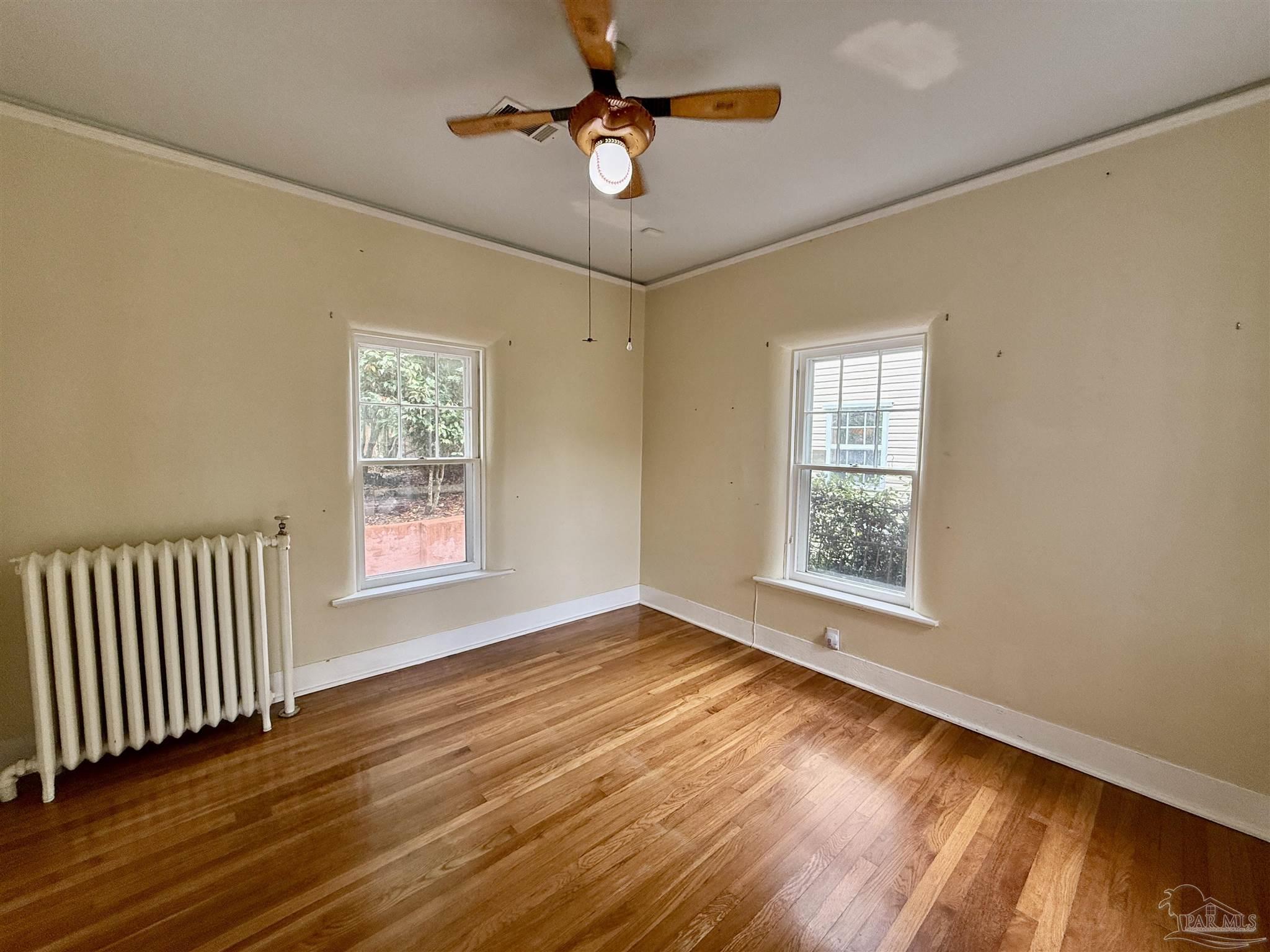 1717 Yates Avenue Pensacola, FL 32503 - Photo 9 of 47 a view of an empty room with window and wooden floor