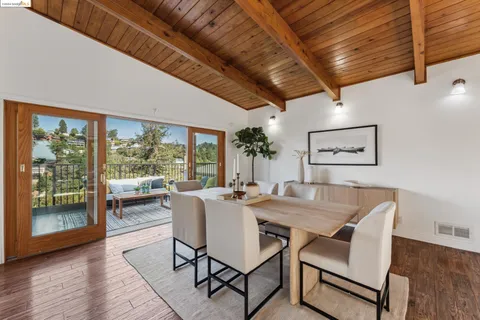 a view of a dining room with furniture wooden floor and a potted plant