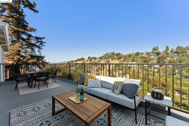 a view of a balcony with two chairs and a table