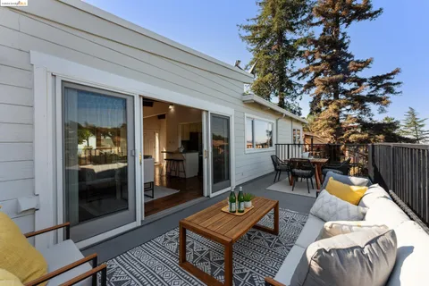 a kitchen with cabinets stainless steel appliances and wooden floor