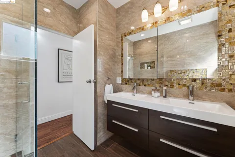 a bedroom with a bed and a painting on the wall