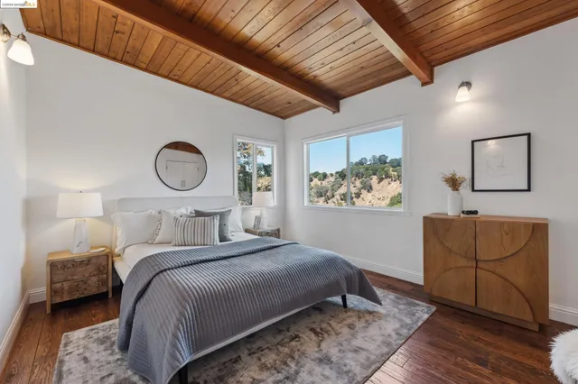 a bedroom with a bed and a chair