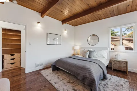 a bedroom with a bed and a mirror